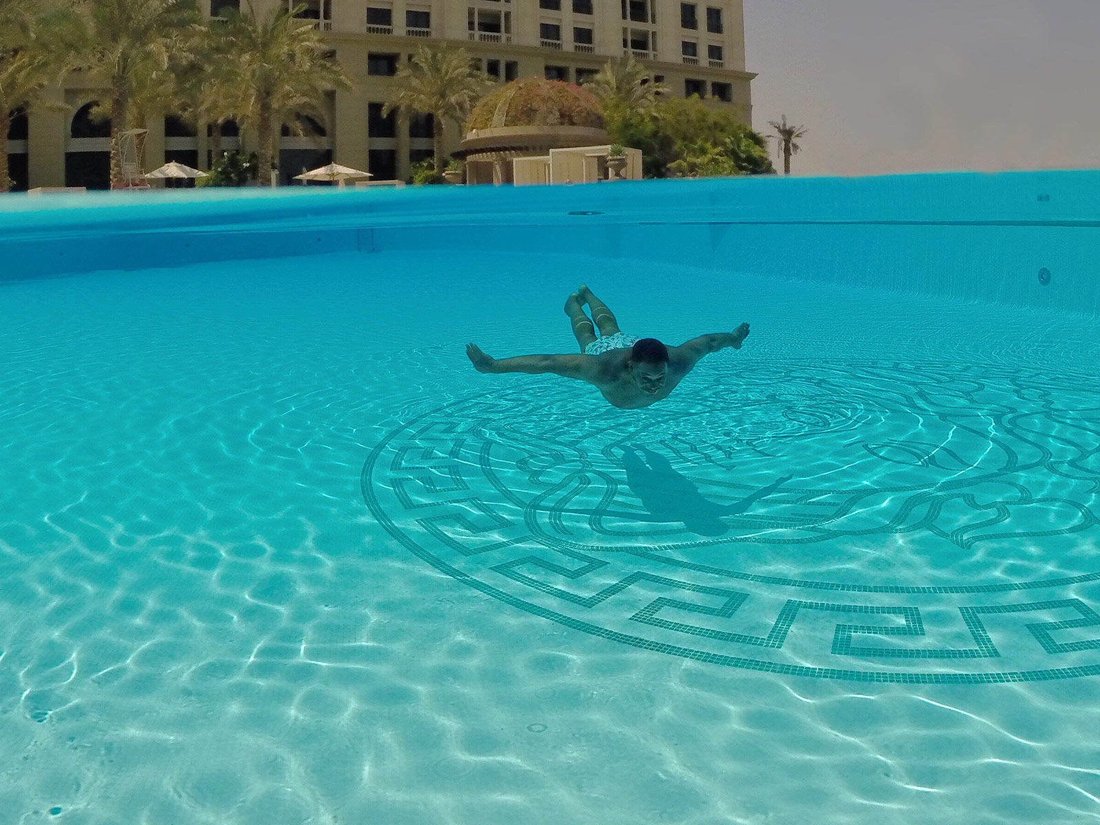 Mase Swimming Over Medusa in the Main Pool at Palazzo Versace Dubai