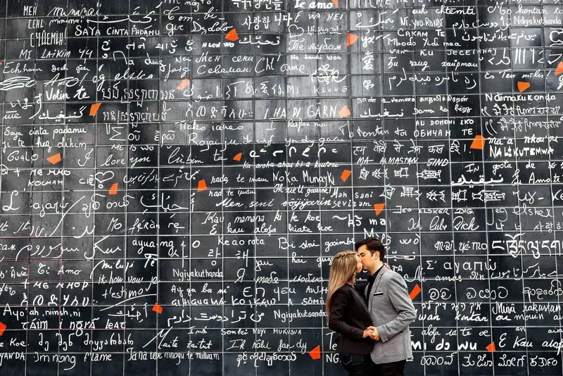 Kissing at the Wall of Love in Montmartre, Paris