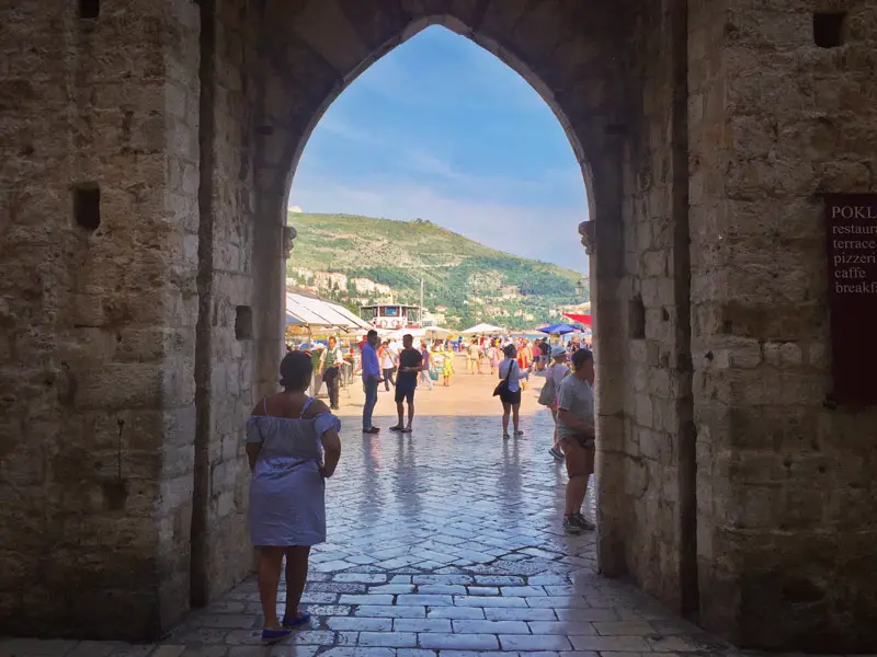 Dubrovnik Croatia - Woman Looking Outside the City Walls to Restaurants