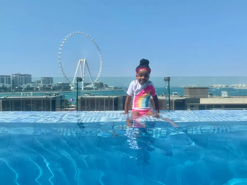 Sofitel Jumeirah Beach - Girl Kid in Rooftop Infinity Pool with Dubai Eye Wheel