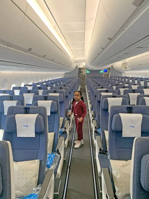 Young Girl on Plane with Empty Seats
