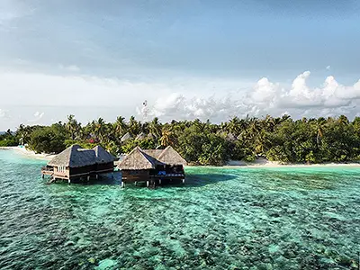 Explore Coral Reefs from a Water Villa