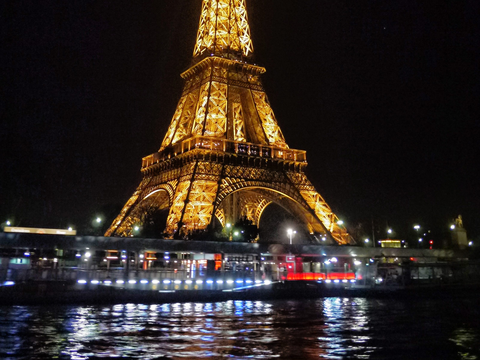 The Brightly Illuminated Eiffel Tower at Night, Paris, France Go To